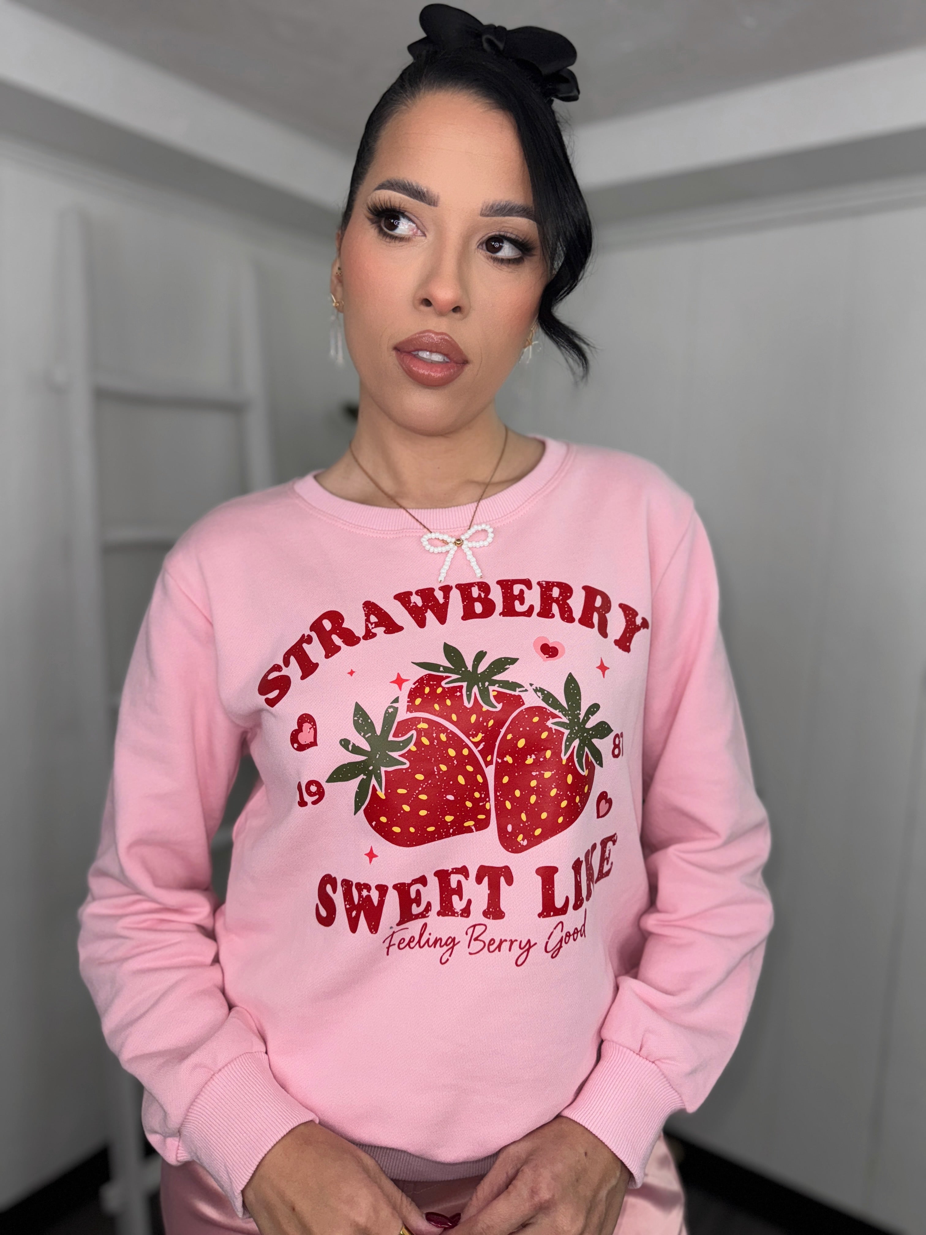 Model wearing Strawberry Sweater, showing the soft pink fabric and cute design.