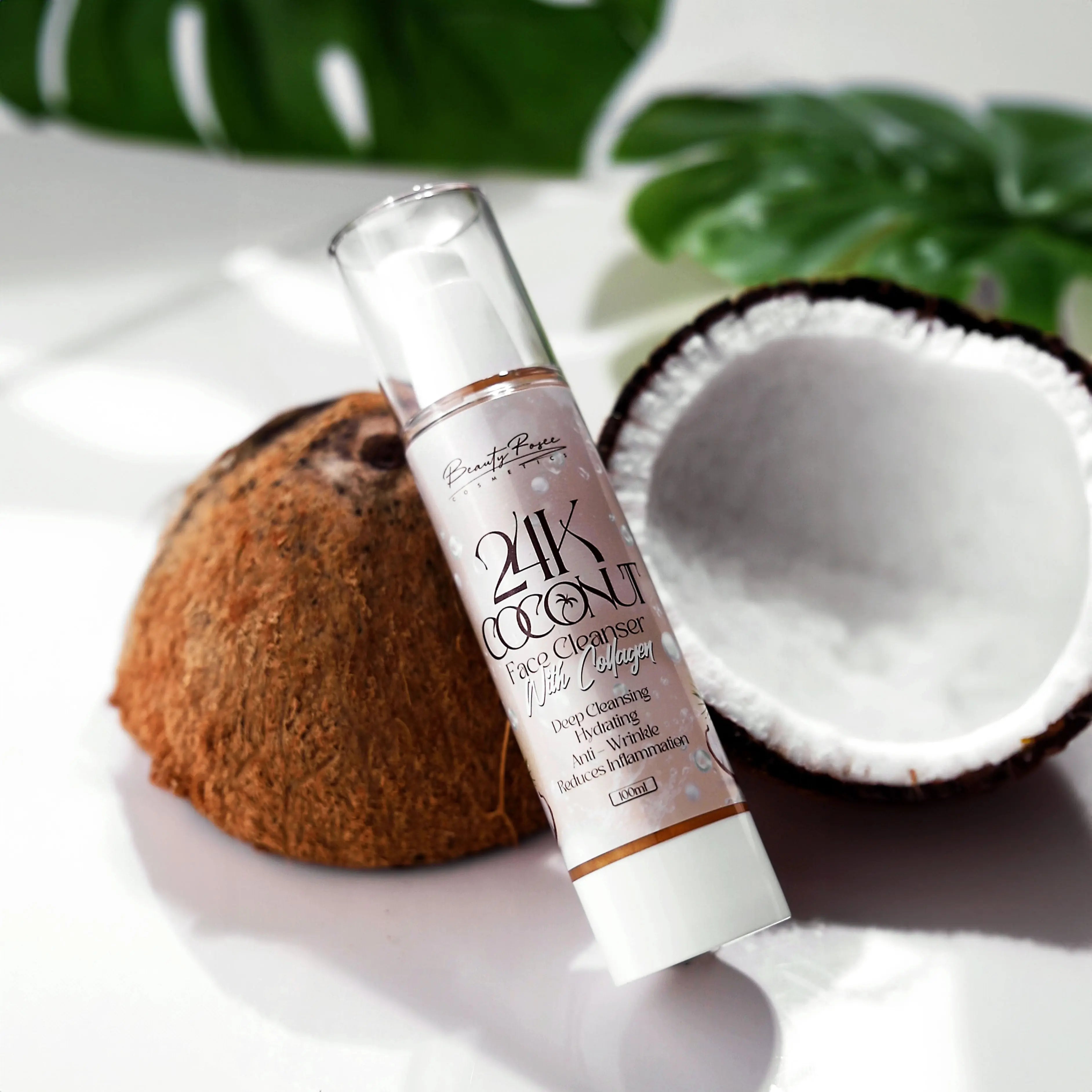 Hand holding 24K Coconut Face Cleanser, infused with gold and collagen for deep cleansing and hydration.