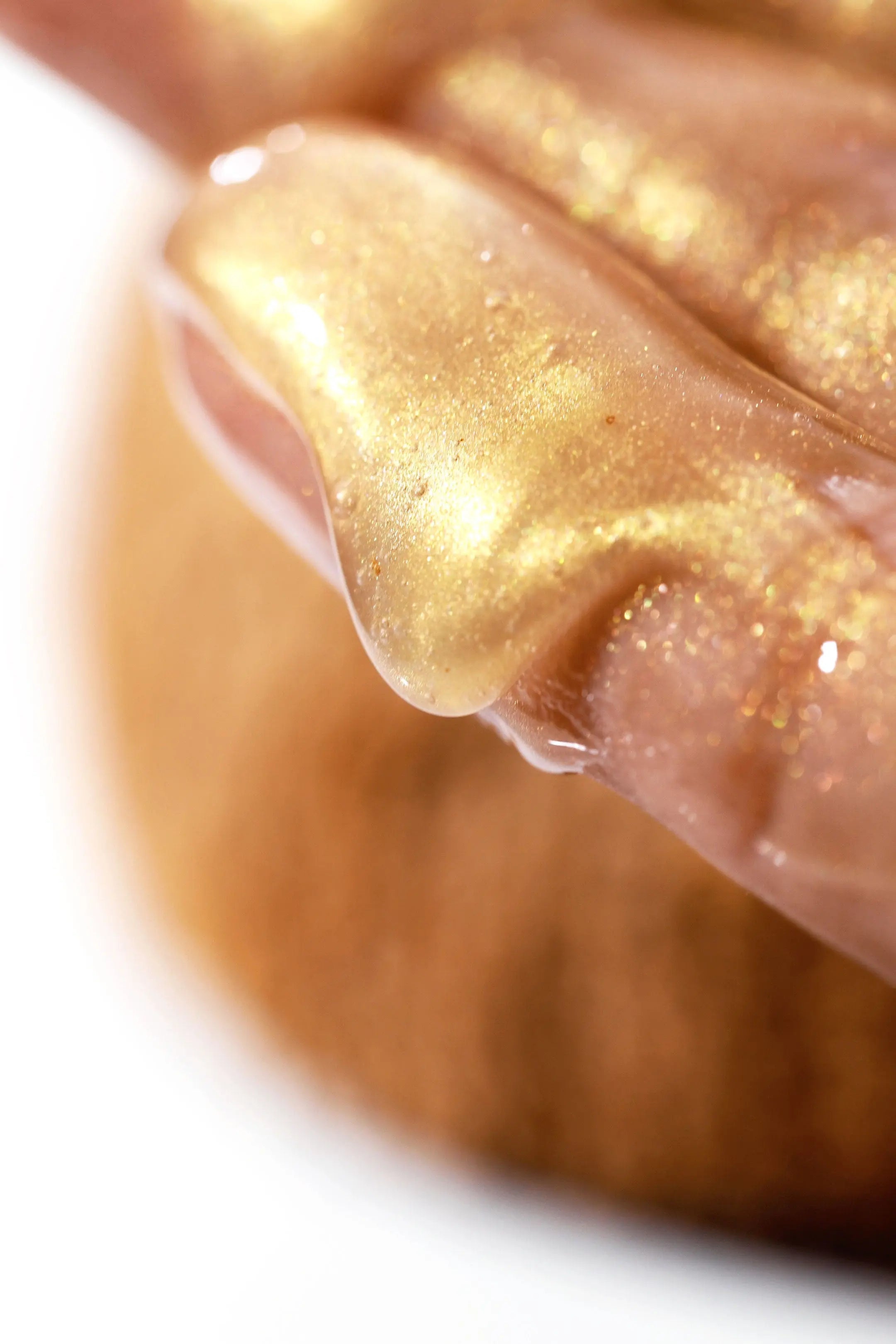 Hand holding 24K Coconut Face Cleanser, infused with gold and collagen for deep cleansing and hydration.