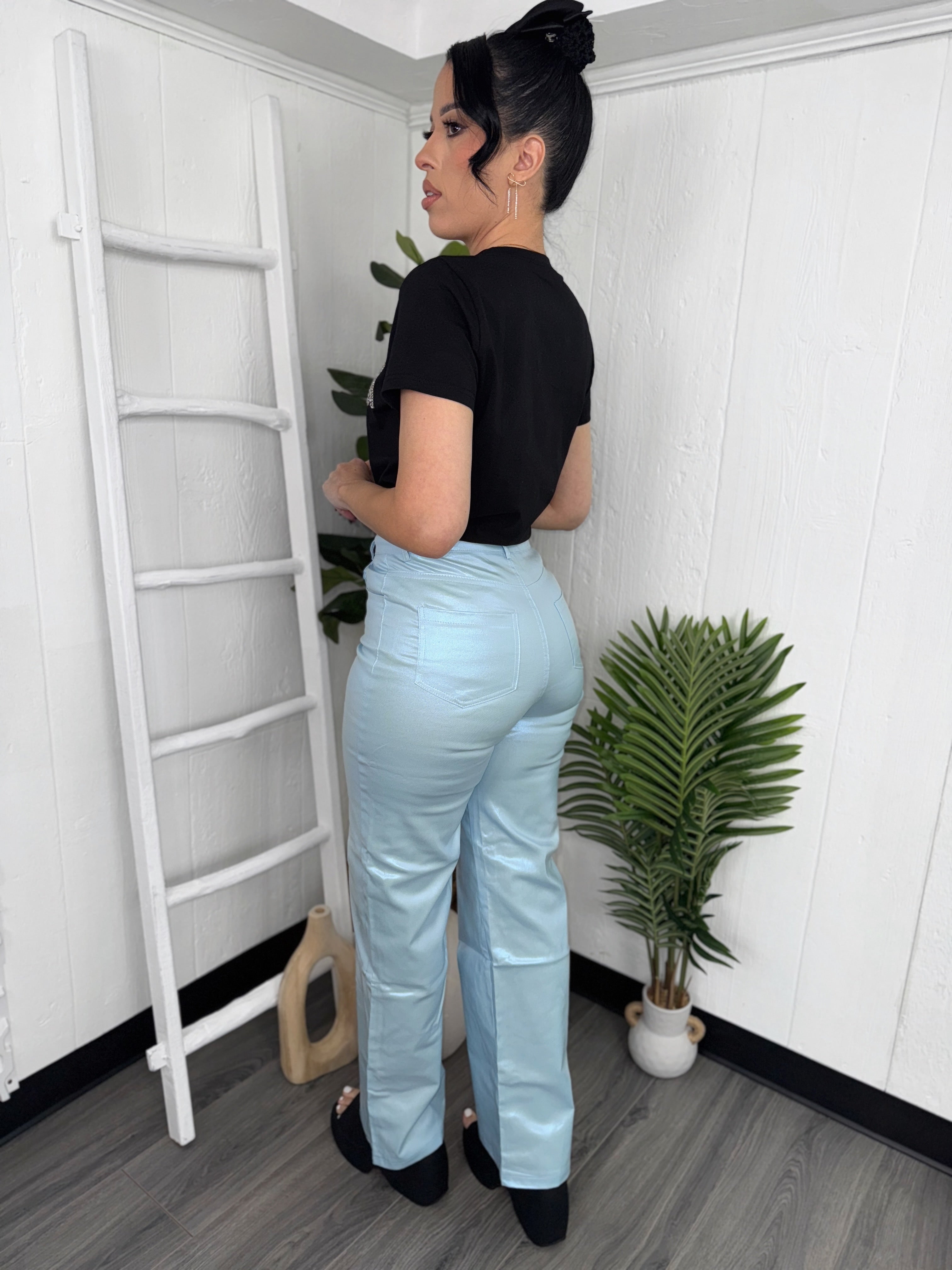 Model wearing Metallic Blue Pants, showcasing their sleek design and vibrant metallic finish.