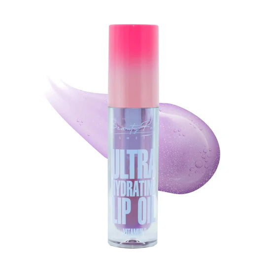 Bottle of Nutella-inspired lip oil with applicator.
Glossy swatch of rich hydrating lip oil.